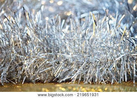 silver tinsel on a gold background for decorating a Christmas festive tree