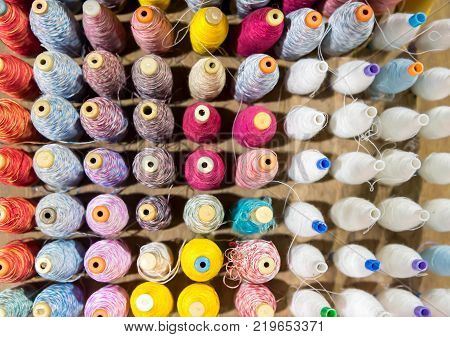Top view A group of old colorful threaded tubes resting Colorful silk