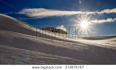 The sun breaking through in the Swiss Alps after a snow storm. Taken nearby the 