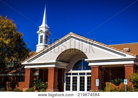 Entrance To Modern Church With White Steeple