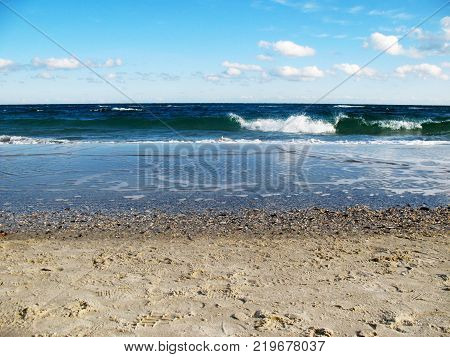 beautiful cloudy sky and the sea with waves in the autumn season