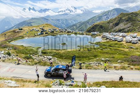 Col de la Croix de Fer France - 25 July 2015: Festina caravan driving on the road to the Col de la Croix de Fer in Alps during the stage 20 of Le Tour de France 2015. Festina is a very old and famous company which produces high quality watches.