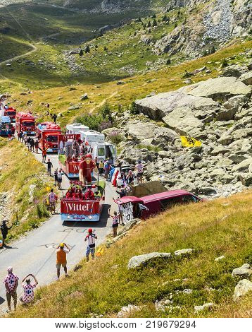 Col de la Croix de Fer France - 25 July 2015: Vittel caravan driving on the road to the Col de la Croix de Fer in Alps during the stage 20 of Le Tour de France 2015. Vittel is a French bottled water brand.