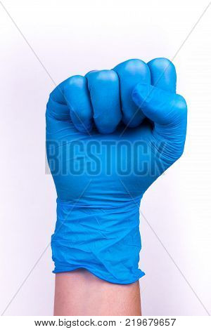 hand in blue glove in a fist scat.