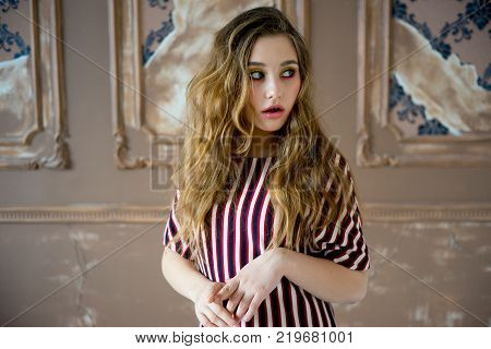 A portrait of a teen girl model in a stdio