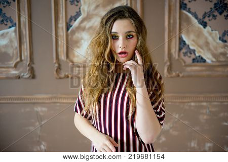 A portrait of a teen girl model in a stdio