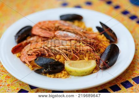 Royal Paella. Tasty Rice with king prawns and mussels