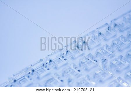 Abstract high-tech background. A sheet of transparent plastic or glass with the cut out holes. Laser cutting of plexiglass.