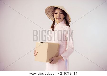 beautiful woman in pink dress and vietnam hat holding box