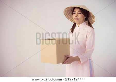 beautiful woman in pink dress and vietnam hat holding box
