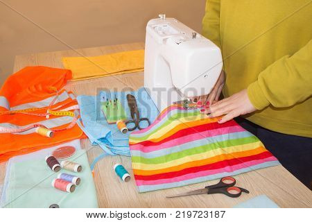 woman hands sewing cloth In Studio. Tailor hands working with scissor and suit textile cloth