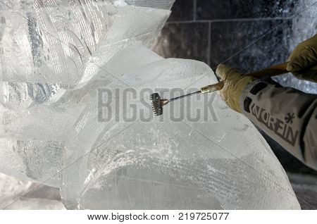 ST. PETERSBURG, RUSSIA - DECEMBER 19, 2017: Sculptor Dmitry Klimenko prepares the statue of griffin for the opening of the festival Ice Fantasy - 2018. This year 180 tonnes of ice was used for statues