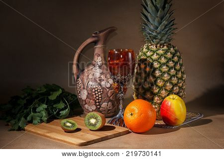 Tropical fruit and a jug on the table display.