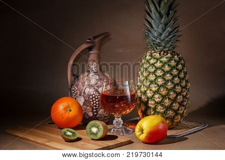 Tropical fruit and a jug on the table display.