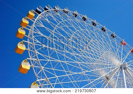 Ferris wheel at Issyk-Kul.
A Ferris wheel is a nonbuilding structure consisting of a rotating upright wheel with multiple passenger-carrying components.
