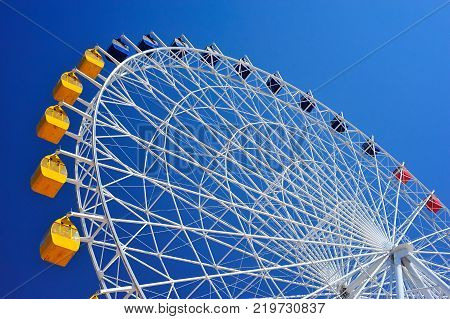 Ferris wheel at Issyk-Kul.
A Ferris wheel is a nonbuilding structure consisting of a rotating upright wheel with multiple passenger-carrying components.