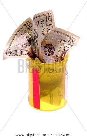Billetes de veinte dólares en la botella de la medicina de prescripción