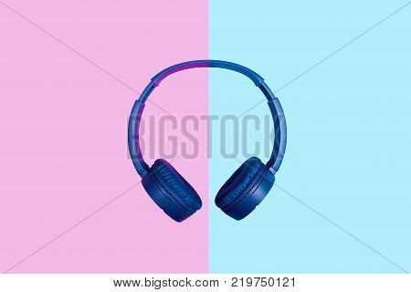 Top view on blue headphones on two colored background. Flat minimal style. Design and colors
