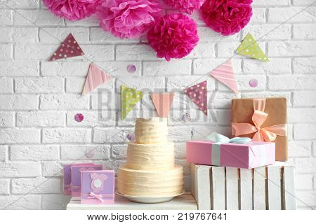 Delicious cake, thank you cards and gift boxes for baby shower party indoors