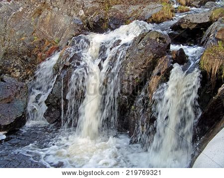 Waterfall From The Thawed Waters. Melting Snow In The Hilly Tundra. Waterfall