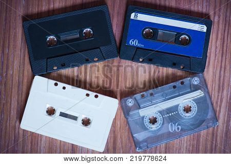 Old music cassettes on a wooden table