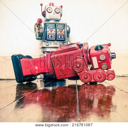 shot down concept with retro tobot toys on a wooden floor with reflection
