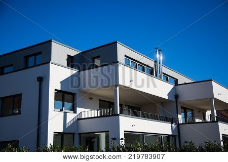 modern multi family house in munich blue sky
