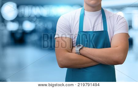 Handyman in uniform is on the blurred background.