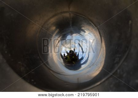 Woman And Child Sliding Inside Metal Pipeline