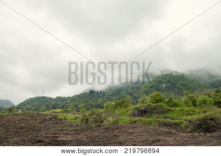 Mountain destroyed by human for cultivate plants. The mist over the hillside.