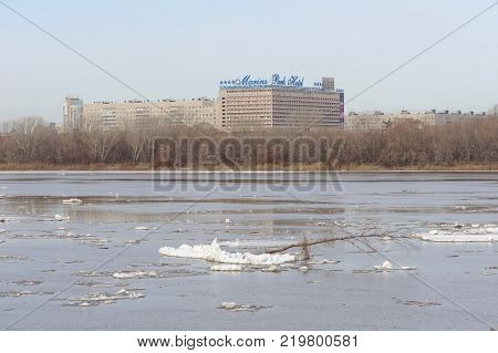 Nizhny Novgorod, Russia. - March 24.2017.View of Marins Park Hotel from the other side of the Oka. The remains of ice floes are floating on the dark water