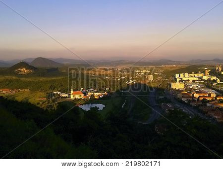 Most Czech republic - July 07 2012: prospect from castle named Hnevin to Most city with 'Nanebevzeti Panny Marie' church during sommer holiday at sunset