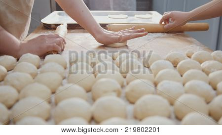 Cook sifts flour and shugar decorating pies in the bakery,