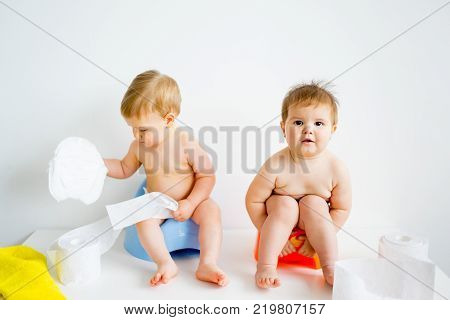 Cute smiling baby sitting on the potty