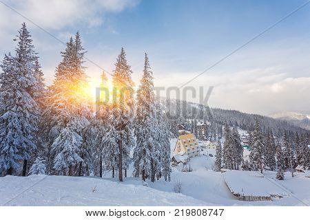 Winter resort with slopes for skiing and snowboarding with houses and lifts