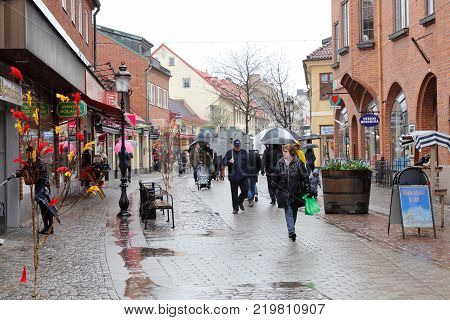 Ystad Sweden - April 15 2017: The Easter decorated shopping street Ostra Storgatan during rain.