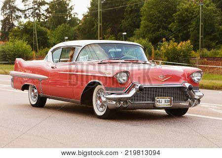 Vasteras Sweden - July 5 2013: One red Cadillac Coupe 1957 during cruising parade at the Power Big Meet event.