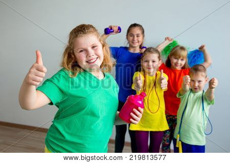 Group of children doing exercises in a gym