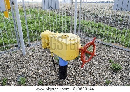 The latch on the underground gas pipeline protected with a fence.