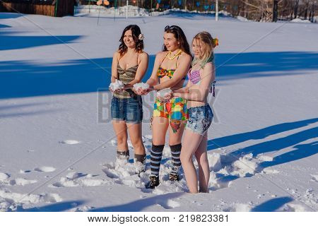 Novokuznetsk, Kemerovo region, Russia-23 Feb, 2017: White beaches of Siberia is an enterteiment activity where people playing beach games dressed in bikini in winter. Women in bikini playing with snow
