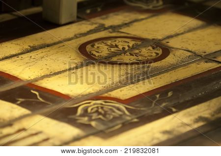 A fragment of a wooden floor with a picture. Selective focus.