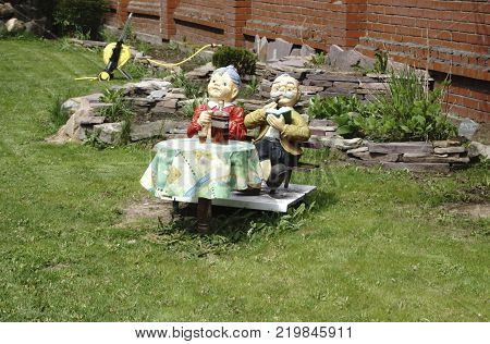 The wooden figure of the person for decoration of a garden or giving