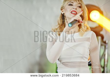 Beautiful Blonde Vocal Singer Girl On Stage.