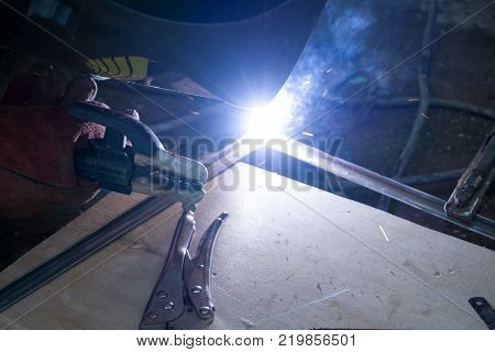 Welders working at the factory made metal