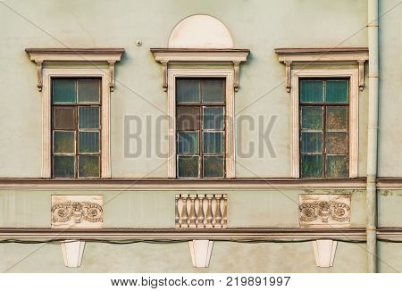 Three windows in a row on the facade of the urban historic building front view, Saint Petersburg, Russia