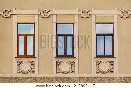 Three windows in a row on the facade of the urban historic building front view, Saint Petersburg, Russia