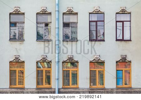 Several windows in a row on the facade of the urban historic building front view, Saint Petersburg, Russia