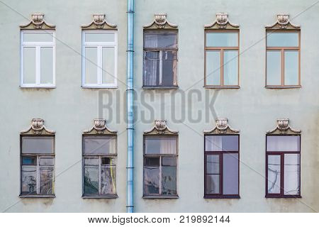 Several windows in a row on the facade of the urban historic building front view, Saint Petersburg, Russia