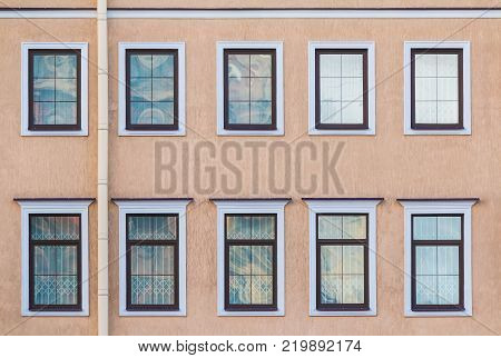 Several windows in a row on the facade of the urban historic building front view, Saint Petersburg, Russia