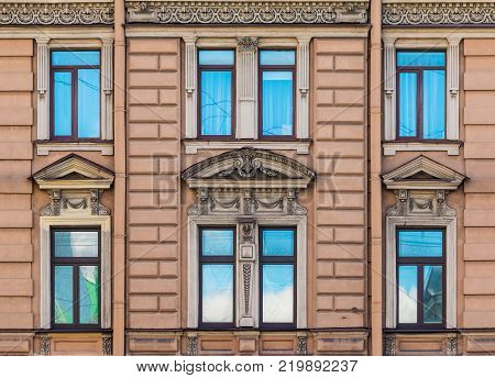 Several windows in a row on the facade of the urban historic building front view, Saint Petersburg, Russia
